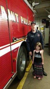(Wolfsberger and his daughter at the Saint Paul fire station)