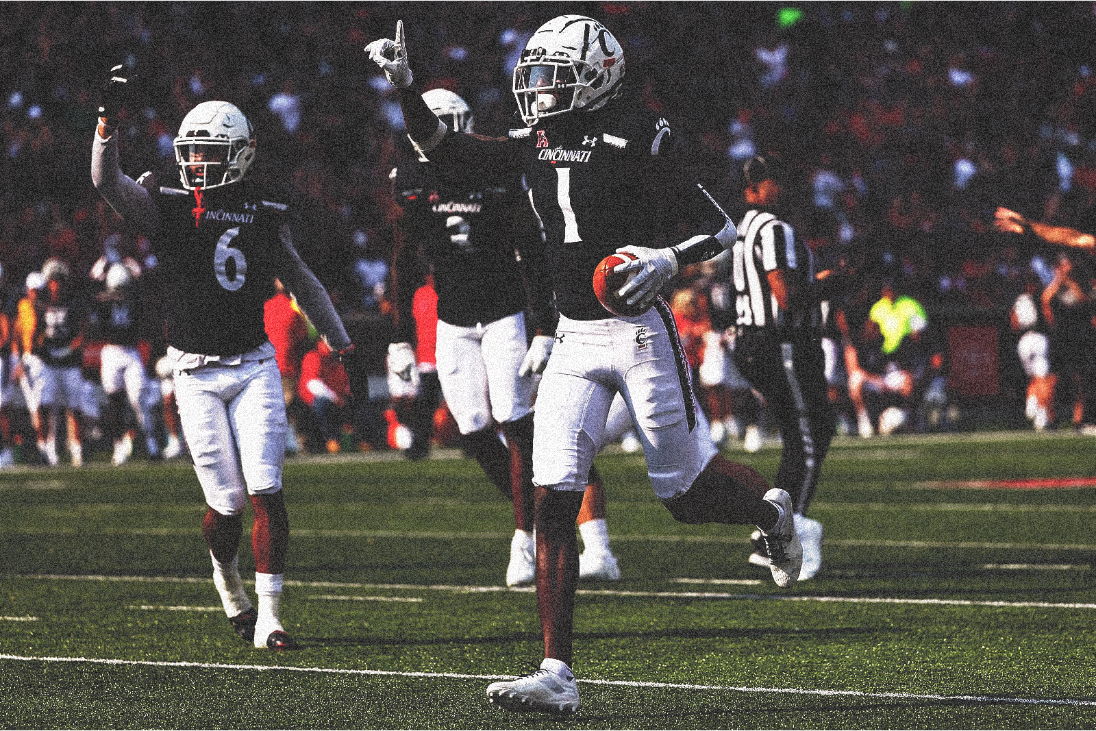 Cincinnati cornerback Ahmad Sauce Gardner holds up a jersey for