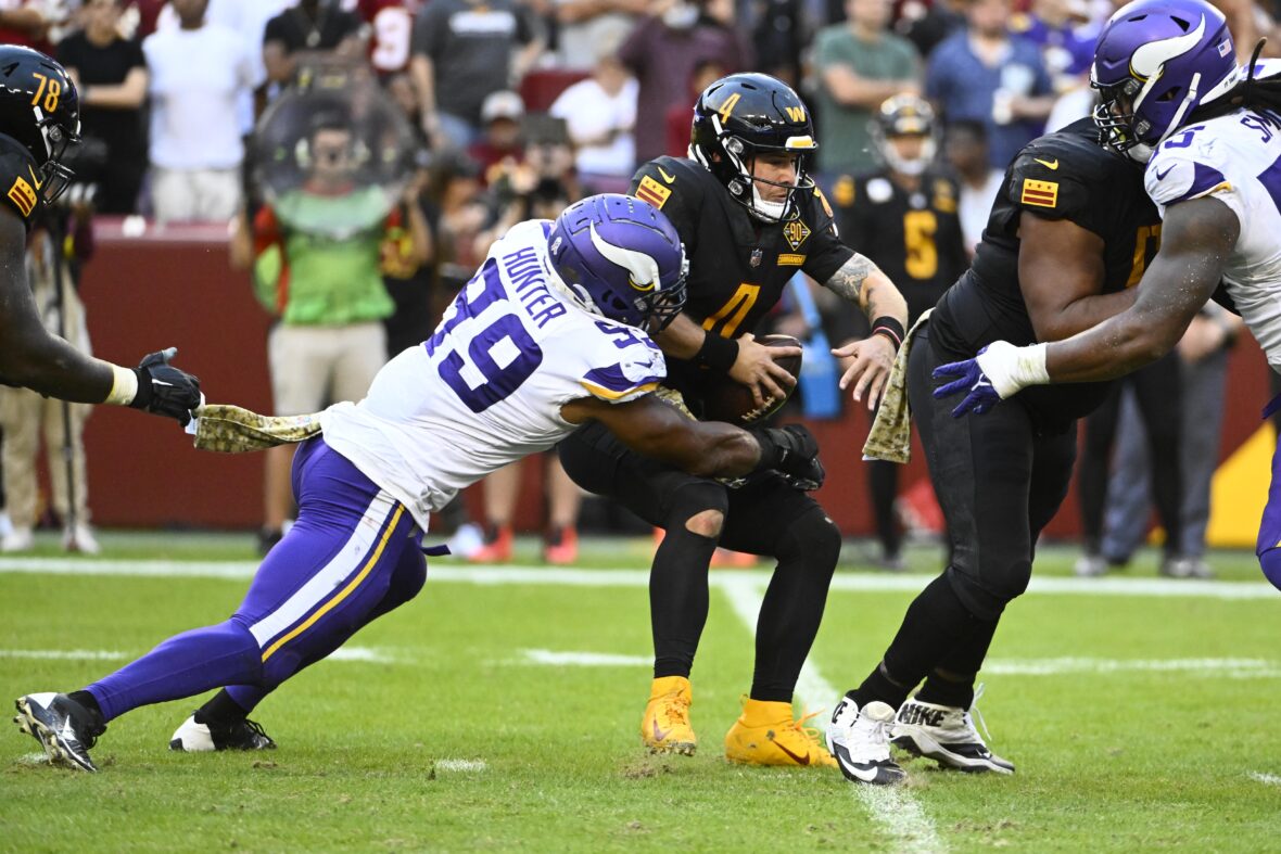 Minnesota Vikings quarterback Taylor Heinicke (6) avoids a sack by