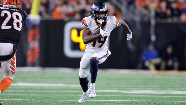 Jaleel McLaughlin runs for a first down against the Bengals.