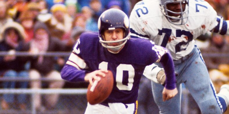 Fran Tarkenton scrambles under pressure from Ed โToo Tallโ Jones in the 1975 playoffs.