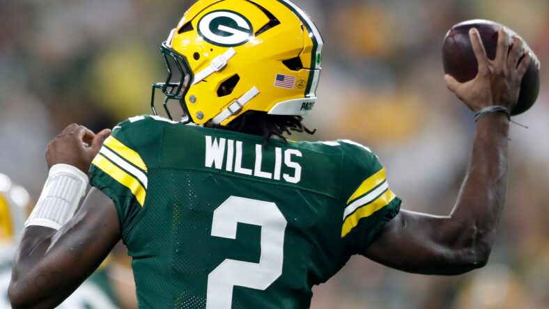 Malik Willis prepares to pass against Jets at Lambeau Field.