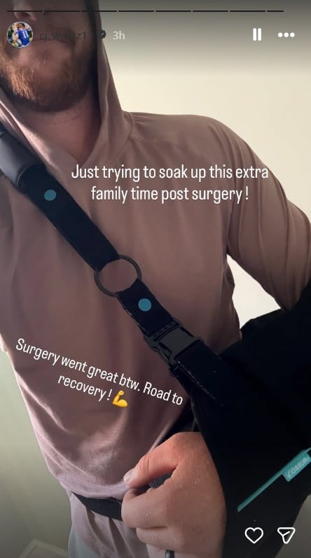 Carson Wentz in a hoodie adjusting a shoulder sling in a close-up Instagram Story photo.
