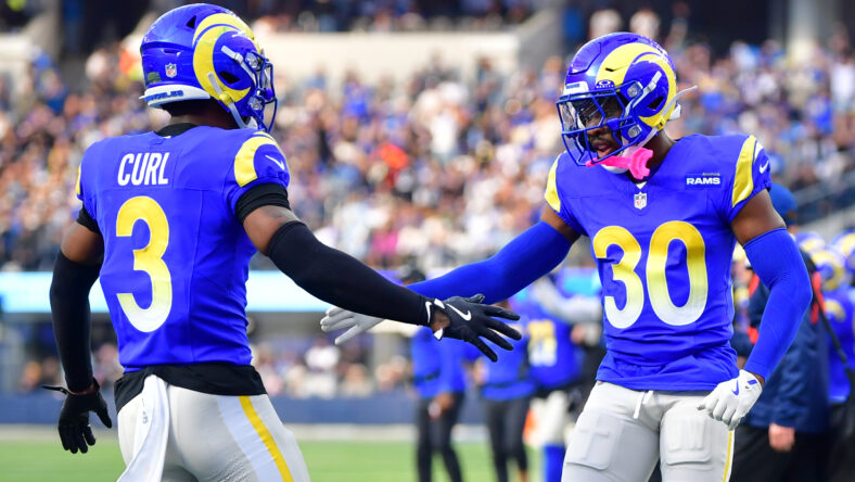 Rams defenders Kam Curl and Josh Wallace high-five after a play at SoFi Stadium.