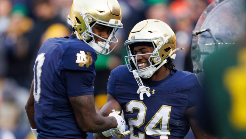 Jadarian Price and Malachi Fields celebrate a touchdown at Notre Dame Stadium.